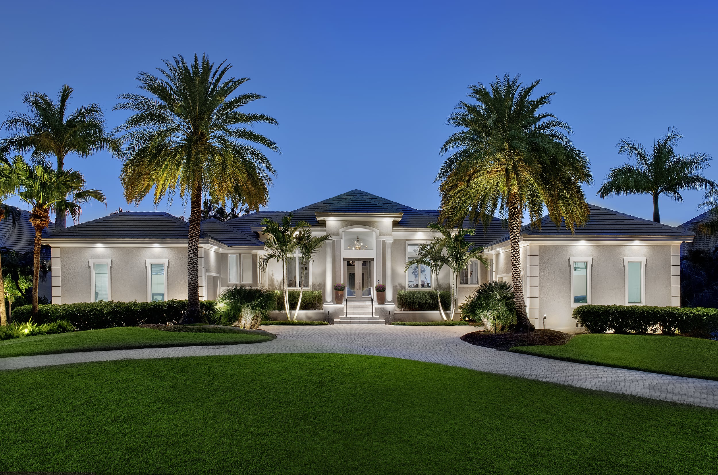 Warm uplighting on trees and façade