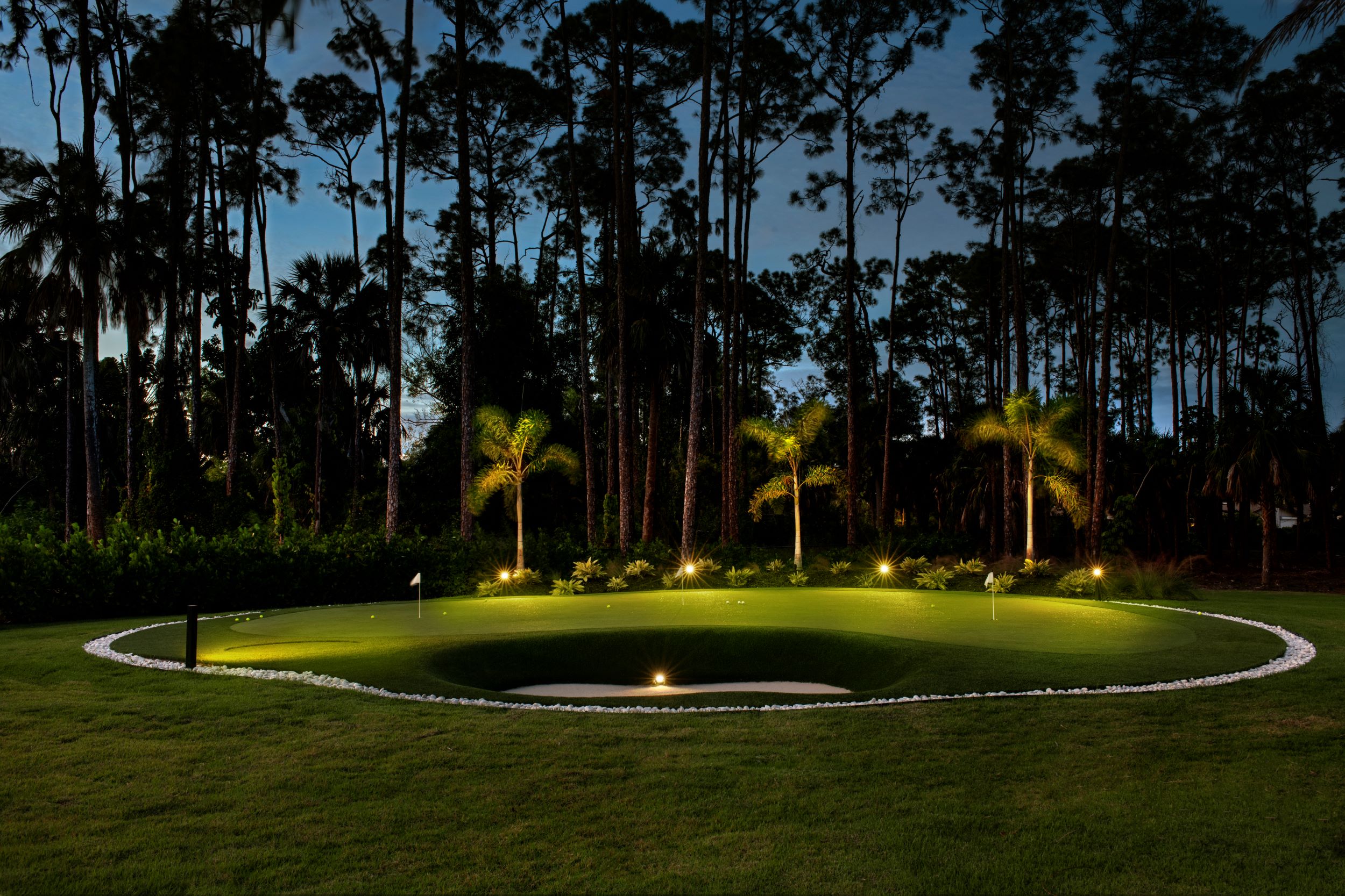 Putting green with landscape lighting and path-lighting.