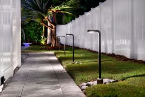 Modern path-lighting illuminating paver walkway in Naples.