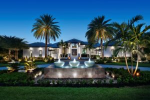 Luxury home in Bonita bay illuminated with architectural lighting, landscape lighting and aquatic lighting.