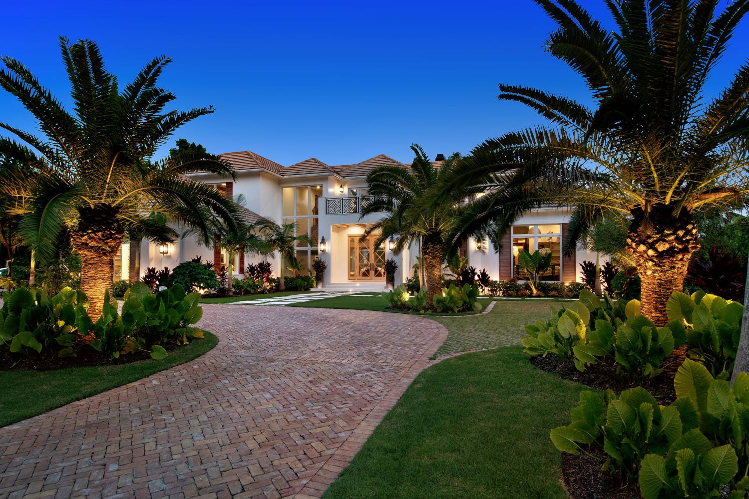 Outdoor lighting project in Port Royal community in Naples,Florida. Home is well illuminated with architectural lighting and landscape lighting.